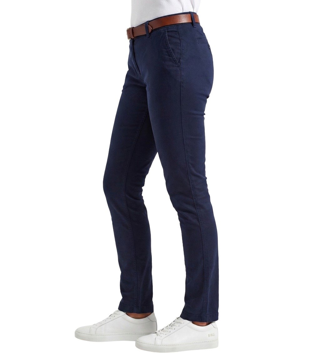Side profile view of Black White Jeans Women's Classic Fit Navy Chinos, showing the straight leg cut and side pocket detail. Paired with white BWJ minimalist sneakers and a brown belt.