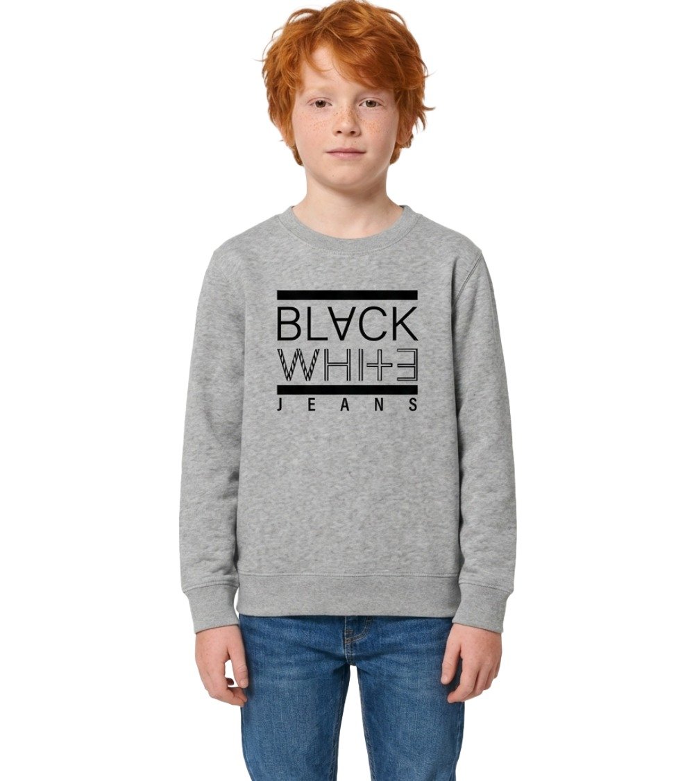 Ginger-haired boy wearing Kid's Heather Grey Crewneck Sweatshirt with black BLACK WHITE JEANS logo and blue jeans on white background.