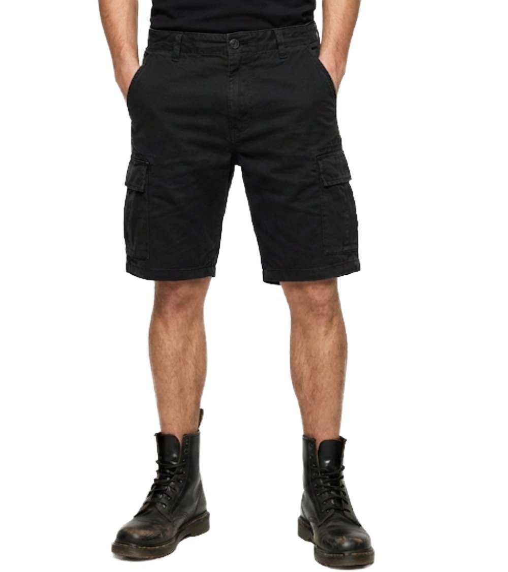 Front view of model wearing Black White Jeans Men's Urban Cargo Shorts styled with combat boots, showing side cargo pockets and regular fit.